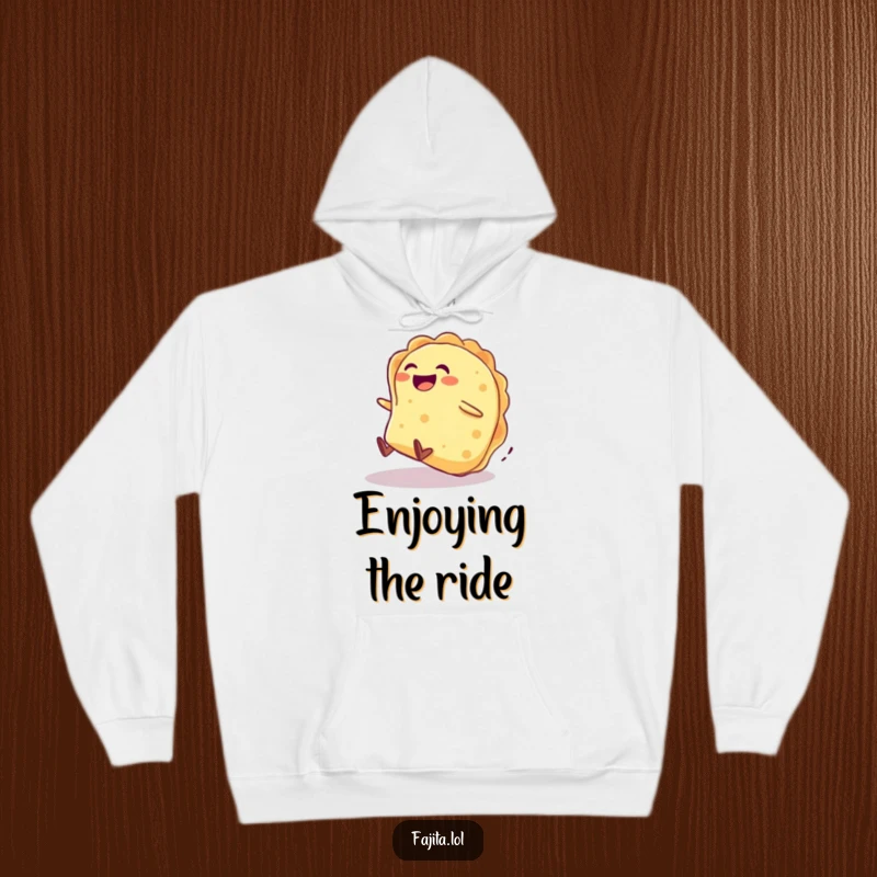 Funny hoodie features a giggling tortilla character joyfully rolling down a hill, offering warmth and amusement.