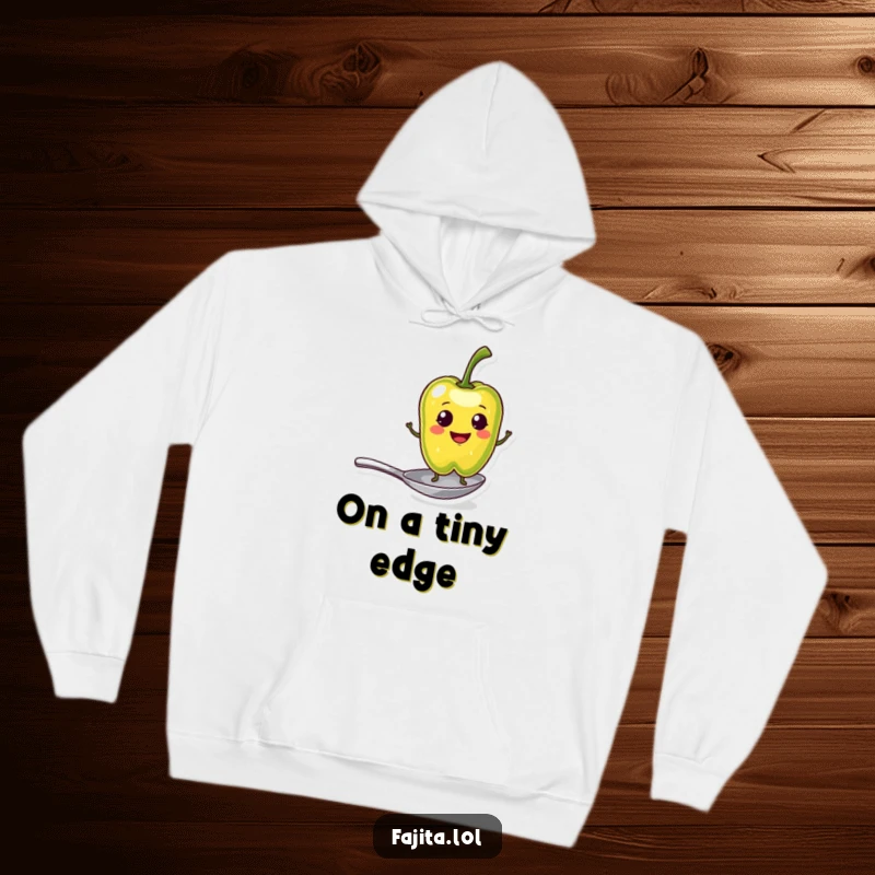 Funny Hoodie featuring a smiling pepper slice character balancing on a tiny spoon, designed for ultimate coziness and spicy personality.